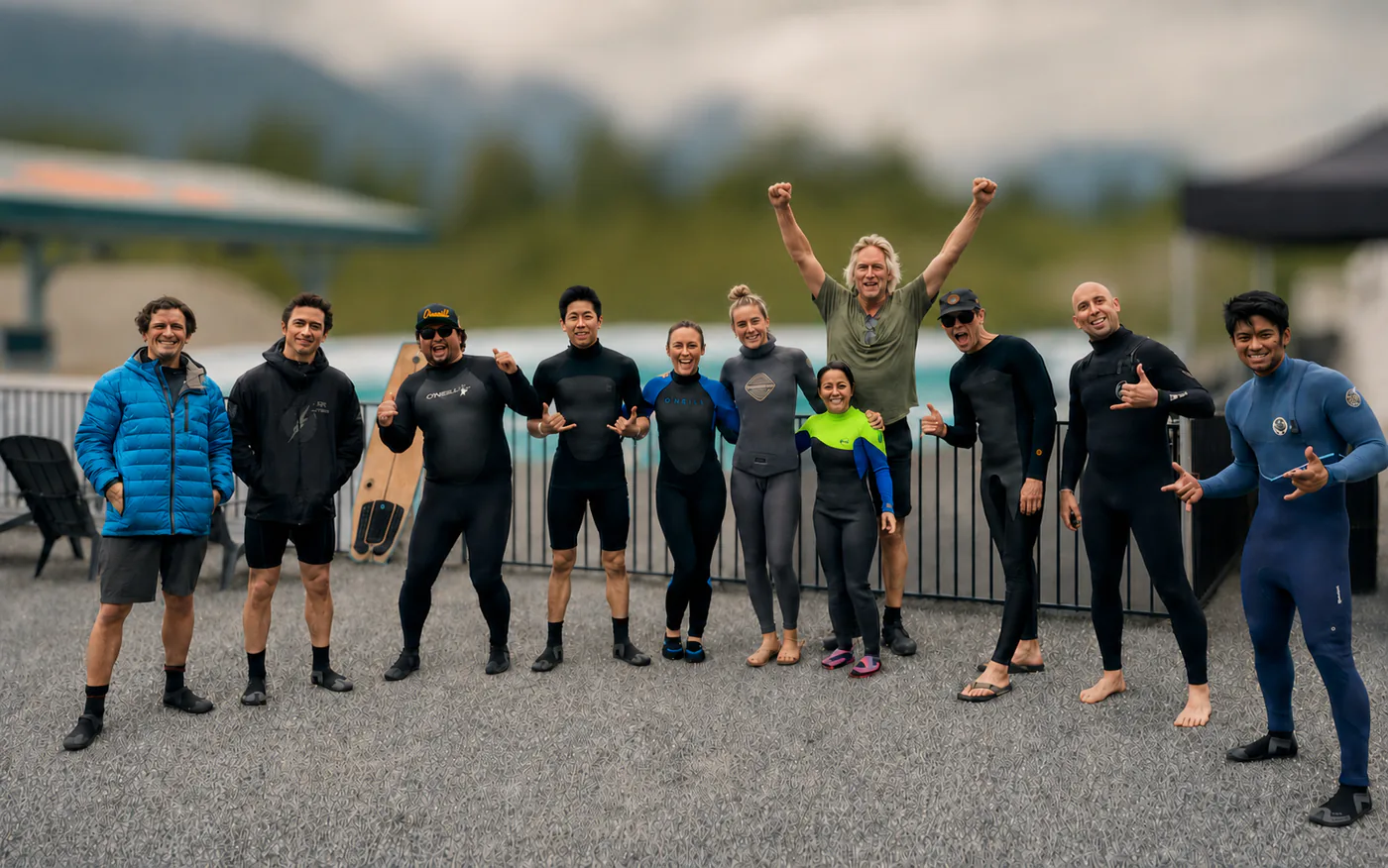 A group of surfers gathered beside a wave pool
