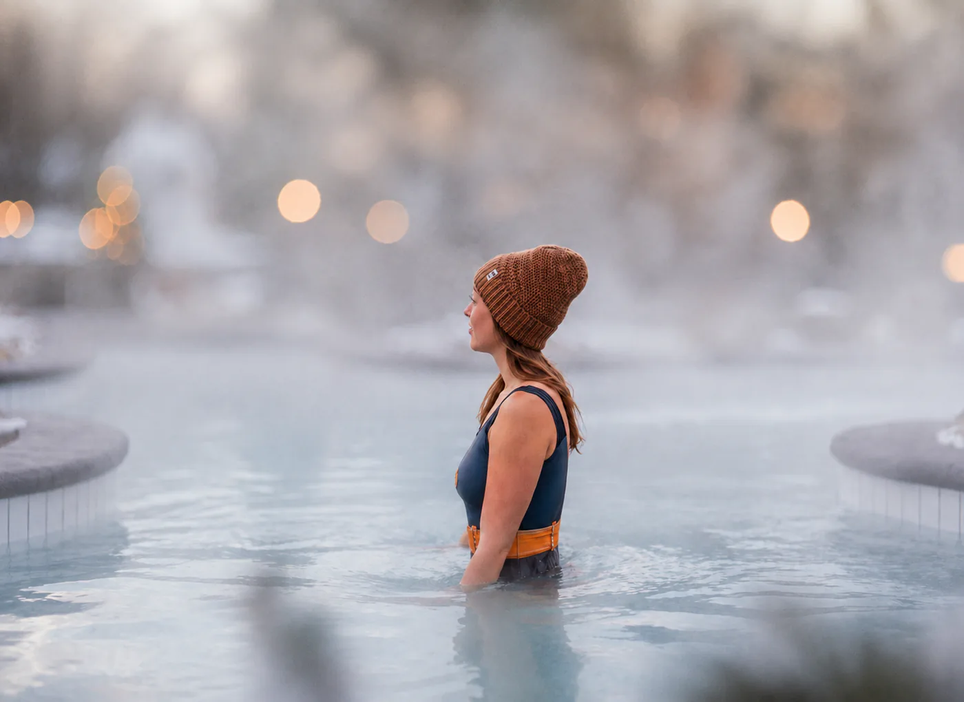 Guest relaxing in a steaming outdoor thermal pool