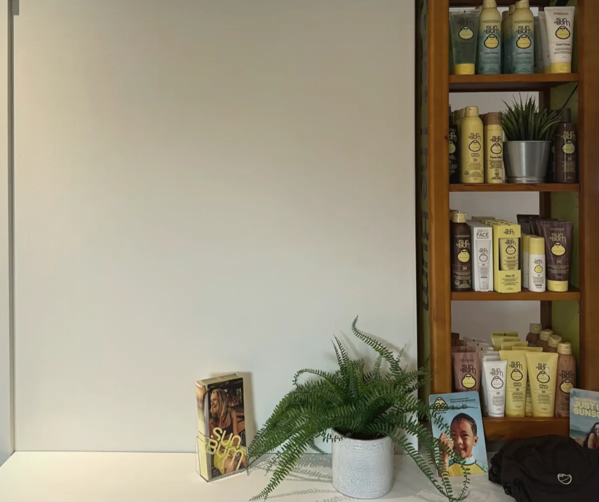 Sun Bum products displayed on wooden shelves in the General Store